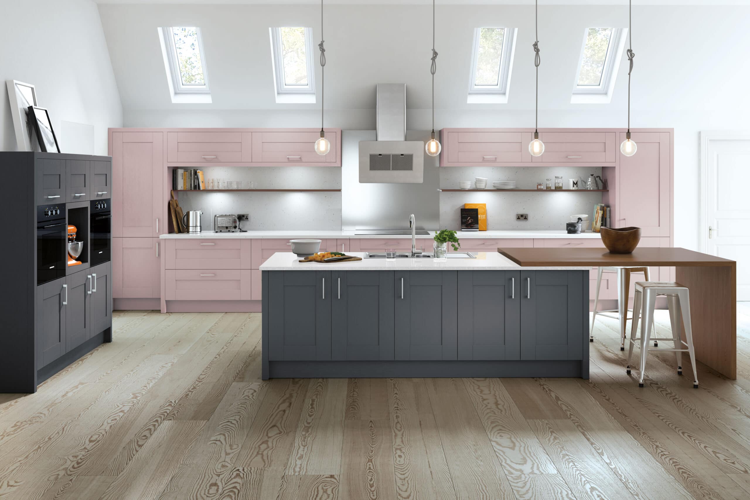 Modern kitchen and bathroom showroom design featuring skylights, pink cupboards, a large grey island with sink, and a wooden breakfast bar with stools. Pendant lights hang above, complementing the wood flooring for a stylish installation supply showcase.